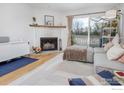 Cozy living room with a fireplace, wood floors, and sliding glass door leading to an outdoor area at 4965 Twin Lakes Rd # 68, Boulder, CO 80301