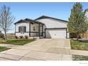 Charming single-Gathering home with a well-manicured lawn and two-car garage at 6021 Sandstone Cir, Erie, CO 80516