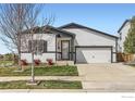 Charming single-Gathering home with a well-manicured lawn and two-car garage at 6021 Sandstone Cir, Erie, CO 80516