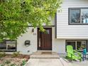 Inviting front entrance featuring a wood door and decorative accents and a green chair at 6672 Welch Ct, Arvada, CO 80004