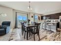 Open dining and kitchen area featuring stylish flooring and a view to the outside at 7231 Clarke Dr, Frederick, CO 80530