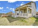 The home has a large backyard, patio with a pergola, and lush green grass at 724 Dakota Ln, Erie, CO 80516