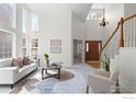 Inviting living room with soaring ceilings, a staircase, and a view of the entryway at 903 Northern Way, Superior, CO 80027