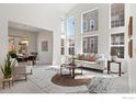 Bright living room featuring high ceilings, large windows, and stylish furniture at 903 Northern Way, Superior, CO 80027