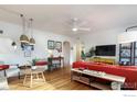 Inviting living room with hardwood floors, stylish furnishings, and a ceiling fan at 1148 Gay St, Longmont, CO 80501
