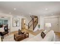 Spacious living room with modern staircase, with an adjacent dining room visible at 1496 Greenbriar Blvd, Boulder, CO 80305