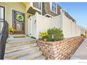 Charming entry with steps leading to a front door adorned with a colorful wreath at 15503 E Wyoming Dr # G, Aurora, CO 80017