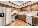 Cozy kitchen featuring stainless steel appliances, wood cabinets, and hardwood floors at 15503 E Wyoming Dr # G, Aurora, CO 80017