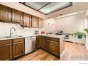 Bright kitchen boasts wood cabinets, skylight and leads to adjacent breakfast nook at 15503 E Wyoming Dr # G, Aurora, CO 80017