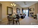 Open-concept living space with dining area next to living room and fireplace at 1703 Whitehall Dr # 6I, Longmont, CO 80504