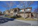 Exterior of a modern building showing architectural details, balconies, and well-maintained landscaping at 1703 Whitehall Dr # 6I, Longmont, CO 80504
