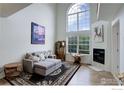 Bright living room offering ample natural light, stylish decor, and a cozy fireplace at 1757 High Plains Ct, Superior, CO 80027