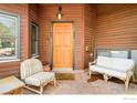 Inviting front porch with comfortable seating and charming wood door at 1800 Sumac Ave, Boulder, CO 80304