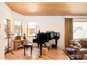 Cozy living room with hardwood floors, piano, and natural light at 1800 Sumac Ave, Boulder, CO 80304
