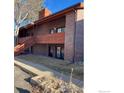 Exterior view of an apartment building, showcasing the brick facade and wood trim with a staircase at 1961 Centennial Dr, Louisville, CO 80027