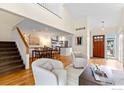 Open-concept living space showcasing hardwood floors, staircase, and a view of the kitchen at 1990 Joslyn Pl, Boulder, CO 80304