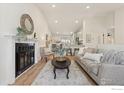 Open-concept living room and kitchen featuring a fireplace and modern design at 2476 Sunset Dr, Longmont, CO 80501