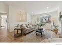Inviting living room with wood floors, neutral tones, and a large window at 2476 Sunset Dr, Longmont, CO 80501