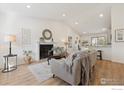 Cozy living room with fireplace and view of the kitchen at 2476 Sunset Dr, Longmont, CO 80501