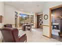 Bright office space with large windows, built-in bookshelves, and an attached half-bathroom at 24771 Westridge Rd, Golden, CO 80403