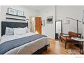 Comfortable bedroom with hardwood floors, a stylish bed, and ample natural light creates an inviting retreat at 2955 N Columbine St, Denver, CO 80205