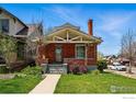 Charming brick home featuring a cozy front porch and well-maintained lawn at 3059 N York St, Denver, CO 80205