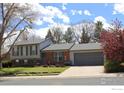 Lovely split-level home with a well-manicured front lawn and a two-car garage at 308 Baron Ave, Lafayette, CO 80026