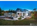 A modern home showcasing a well-designed backyard with patio, outdoor seating, and a hot tub at 310 Linden Ave, Boulder, CO 80304