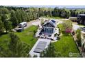 Backyard aerial view features lush greenery, a deck with a hot tub, and a vintage Airstream trailer at 310 Linden Ave, Boulder, CO 80304