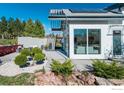 A modern house featuring a patio area with outdoor seating and beautiful landscaping at 310 Linden Ave, Boulder, CO 80304