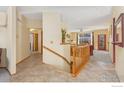 Inviting entryway featuring neutral walls, tile flooring, and a staircase to the lower level at 329 Marmot Pt, Lafayette, CO 80026