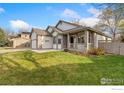 Charming single-Gathering home with a covered porch and a well-maintained front yard at 329 Marmot Pt, Lafayette, CO 80026
