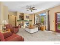 Comfortable living room with a fireplace, large window, and neutral carpet at 329 Marmot Pt, Lafayette, CO 80026