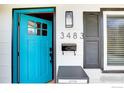 Close-up of a modern front door with stylish hardware, a letterbox, and the house number displayed at 3483 S Glencoe St, Denver, CO 80222