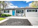 Attractive single-Gathering home with a vibrant blue front door, tidy landscaping, and black shutters at 3483 S Glencoe St, Denver, CO 80222