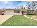 Charming single-story brick home with an attached garage, and a well-manicured front lawn at 375 Kohl St, Broomfield, CO 80020