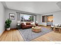 Bright living room featuring hardwood floors, a large window, and contemporary furnishings at 375 Kohl St, Broomfield, CO 80020