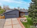 Home featuring a two-car garage, charming landscaping, brick walkway and covered porch at 4734 Hampshire St, Boulder, CO 80301