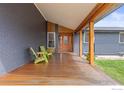 Inviting covered porch with wood flooring and timber columns, perfect for outdoor relaxation at 4734 Hampshire St, Boulder, CO 80301