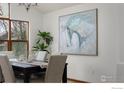 Elegant dining area features a stylish chandelier, painting, and large windows at 4866 Franklin Dr, Boulder, CO 80301