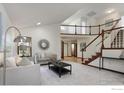 Bright living room featuring vaulted ceilings, a staircase, and neutral decor at 4866 Franklin Dr, Boulder, CO 80301