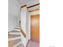 Inviting entryway featuring stairs with wooden trim and a wood door at 5035 W 73Rd Ave, Westminster, CO 80030