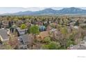 Expansive aerial view of the neighborhood with lush greenery and mountain views in the background at 5285 Gallatin Pl, Boulder, CO 80303