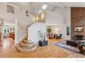 Bright foyer with hardwood floors, a staircase with curved steps, and high ceilings at 5285 Gallatin Pl, Boulder, CO 80303