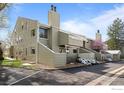 Townhouse exterior with landscaped front yard and parking with blue skies at 6844 Countryside Ln # 284, Niwot, CO 80503