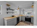 Cozy kitchen with gray cabinetry, stainless steel appliances, and wood countertops at 6844 Countryside Ln # 284, Niwot, CO 80503