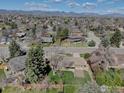 Aerial shot of home highlighting landscaping, neighboring houses, and mountain views at 7136 S Newland St, Littleton, CO 80128