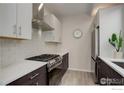 Well-equipped kitchen with stainless steel gas range, modern cabinetry, and quartz countertops at 726 Pearl St # B, Boulder, CO 80302