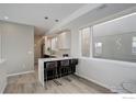 Bright eat-in kitchen features modern finishes, quartz countertops, and bar stool seating at 726 Pearl St # B, Boulder, CO 80302