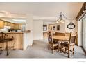 Open dining area with wood table, chairs, and view of the kitchen at 755 Columbine Rd # 303, Breckenridge, CO 80424